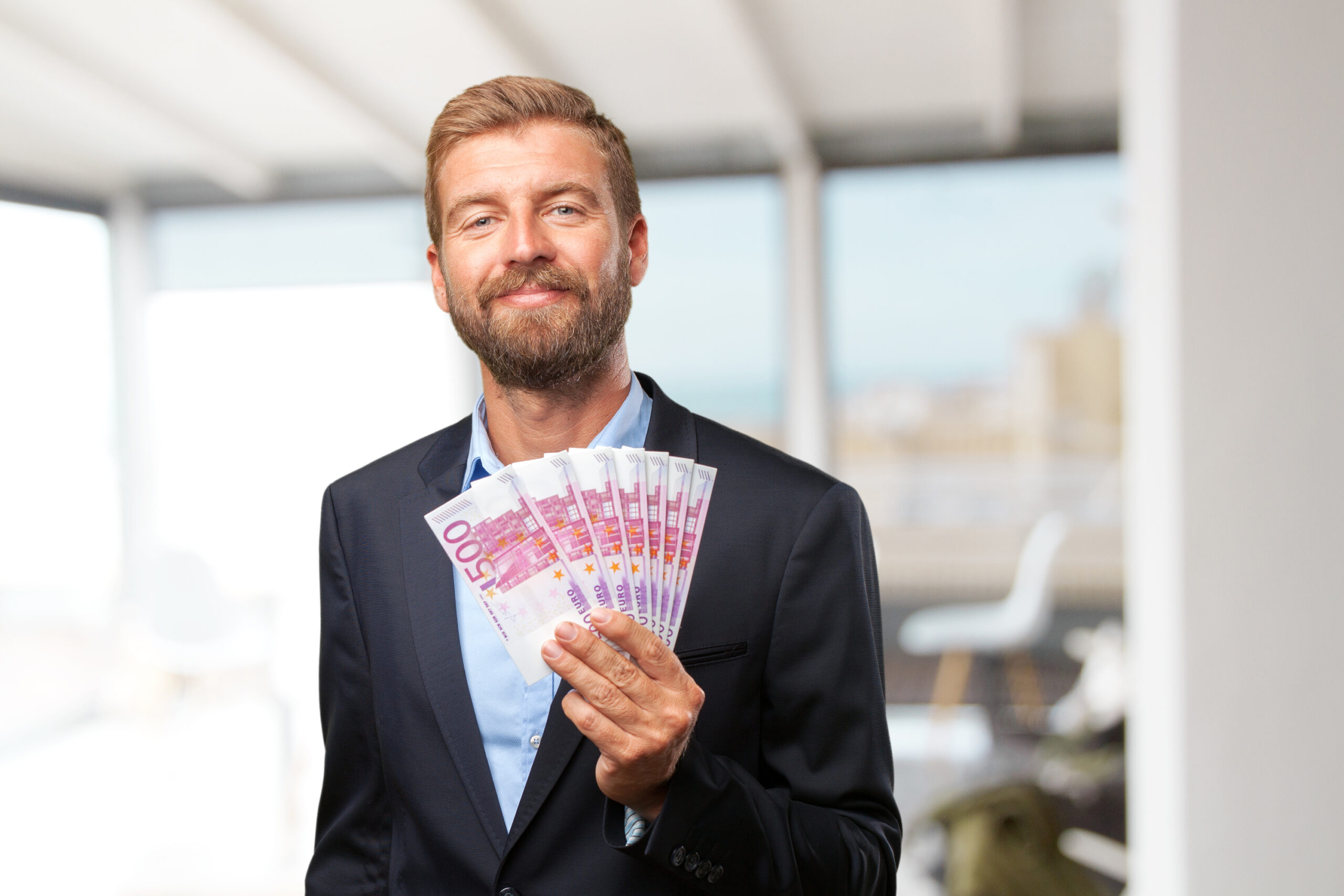 blond businessman happy expression scaled